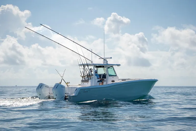 Slide: The Image of 2024 Caymas 34 CT boat cruising on open water under a cloudy sky. - 6