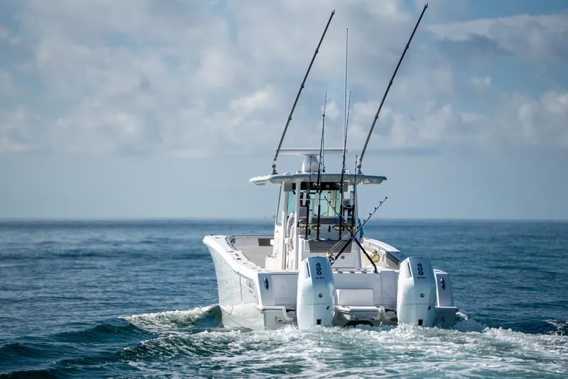 Slide: The Image of 2024 Caymas 34 CT boat cruising on open ocean with fishing rods. - 7