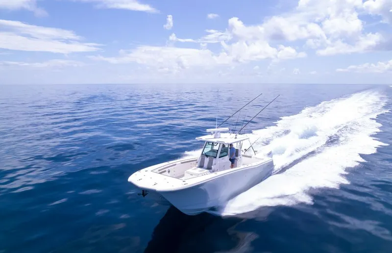 Slide: The Image of 2024 Caymas 34 CT boat cruising on open ocean under clear skies. - 9