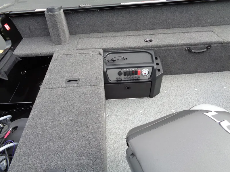 Slide: The Image of 2025 Lund 1650 Rebel XL Tiller interior, featuring seating and control panel. - 11