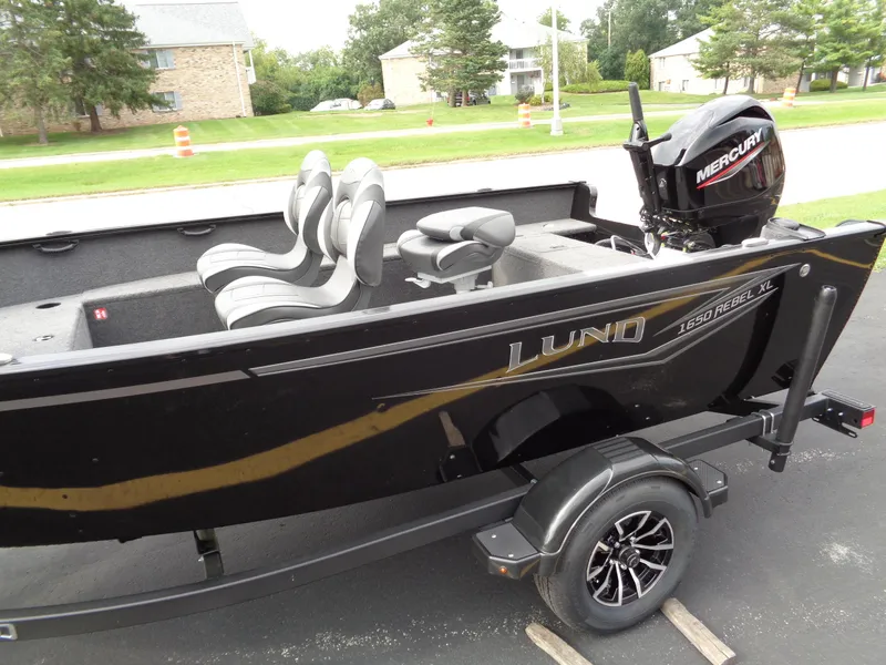 Slide: The Image of 2025 Lund 1650 Rebel XL Tiller boat with Mercury engine on trailer. - 2