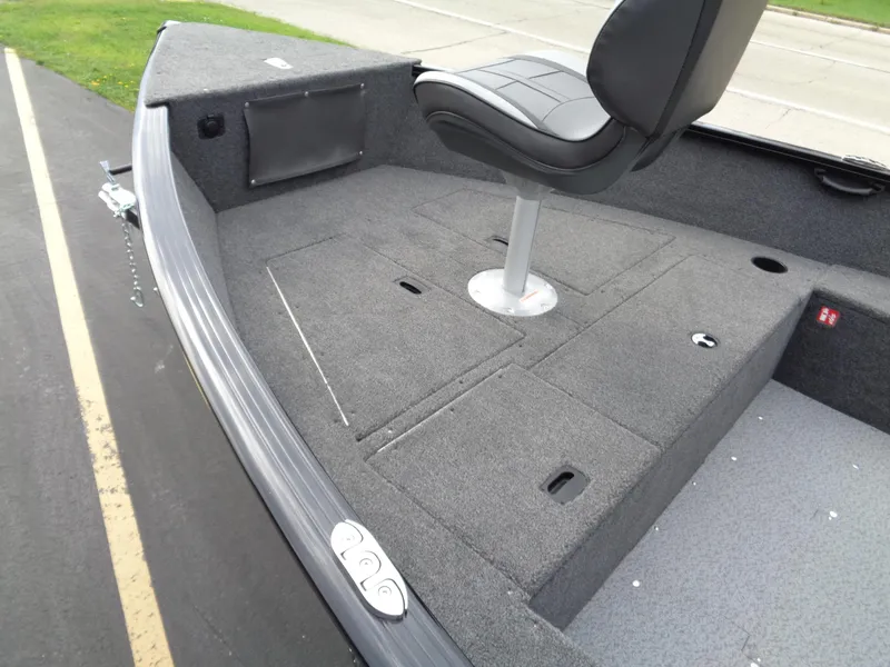 Slide: The Image of 2025 Lund 1650 Rebel XL Tiller boat interior with seating and storage compartments. - 4