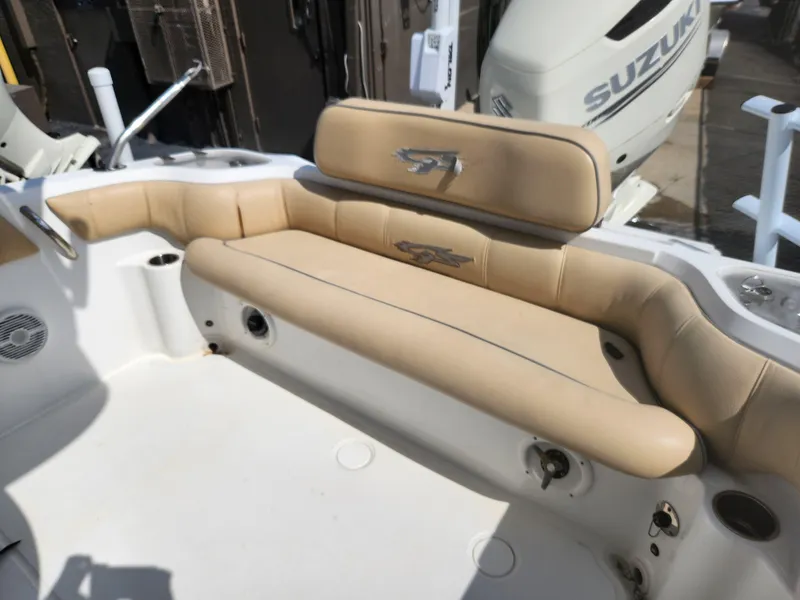 Slide: The Image of 2018 Glasstream 255 Pro-XS boat interior with beige seating and Suzuki engine. - 5