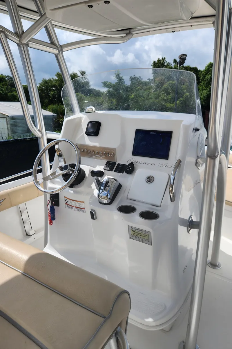 Slide: The Image of 2018 Glasstream 255 Pro-XS boat console with steering wheel and navigation controls. - 7