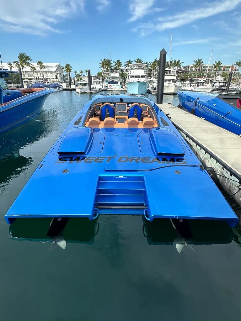 Slide: The Image of Blue Skater 46 powerboat docked in marina, 2013 model, with "Sweet Dreams" text. - 0