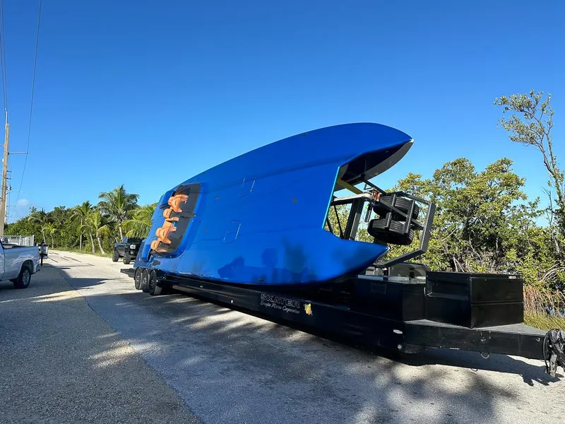 Slide: The Image of Blue Skater 46 boat on trailer, roadside, clear sky, 2013 model. - 2