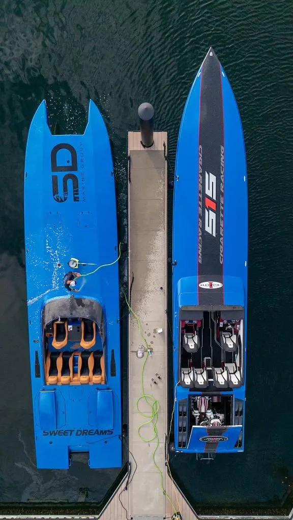 Slide: The Image of Two blue Skater boats docked side by side, aerial view, 2013 model. - 4