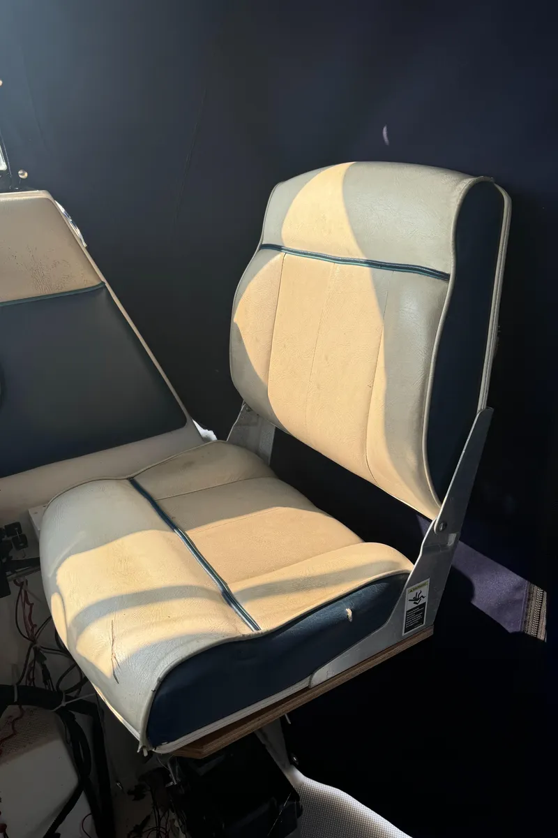 Slide: The Image of 1996 Bayliner 2452 Ciera Express Hardtop boat seat, beige and blue upholstery. - 10