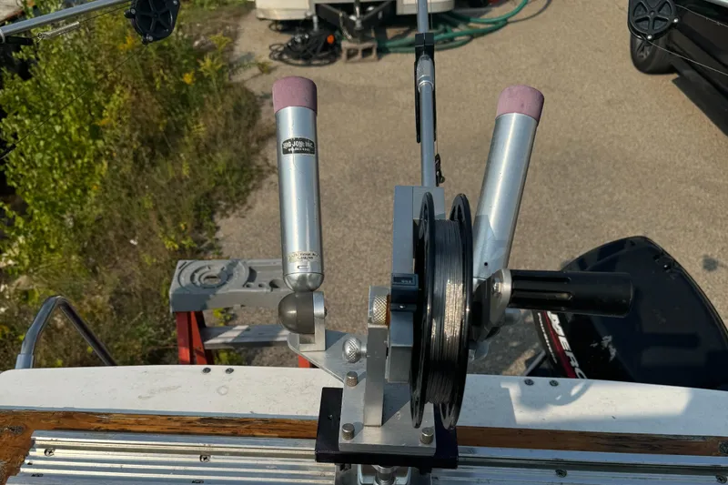Slide: The Image of Fishing rod holders and reel on a 1996 Bayliner 2452 Ciera Express Hardtop boat. - 12