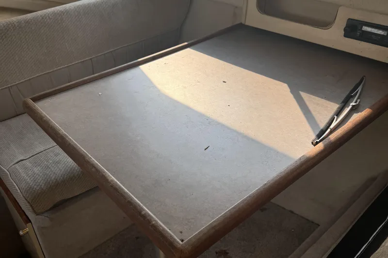 Slide: The Image of Interior table of 1996 Bayliner 2452 Ciera Express Hardtop boat with pen. - 15