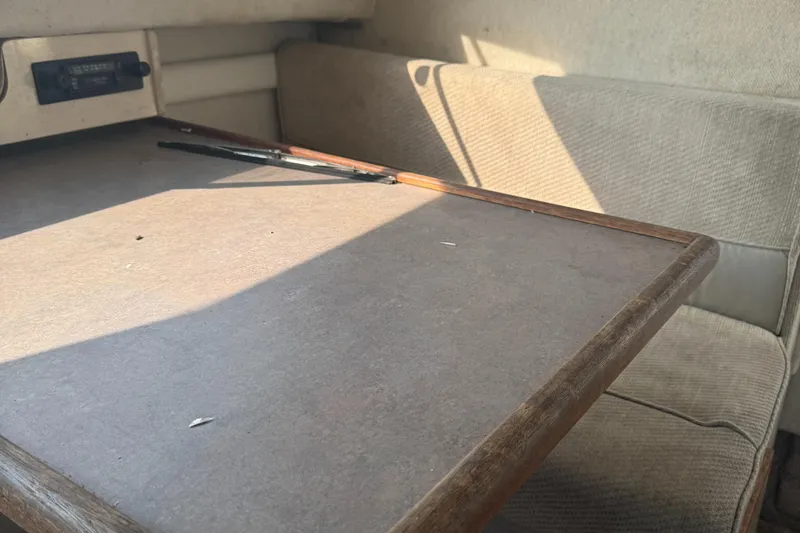 Slide: The Image of 1996 Bayliner 2452 Ciera Express Hardtop interior with table and seating area. - 18