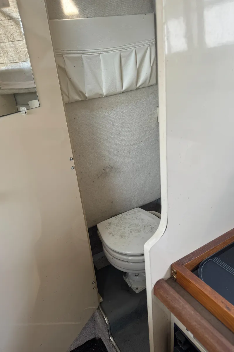 Slide: The Image of 1996 Bayliner 2452 Ciera Express Hardtop boat bathroom interior with toilet. - 19