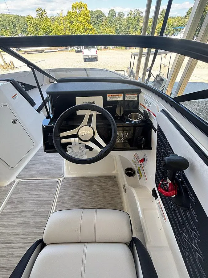 Slide: The Image of 2025 Sea Ray SPX 210 boat cockpit with steering wheel and control panel. - 3