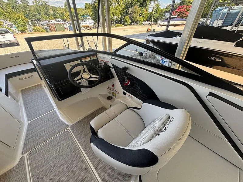Slide: The Image of 2025 Sea Ray SPX 210 boat interior with steering wheel and seating. - 4