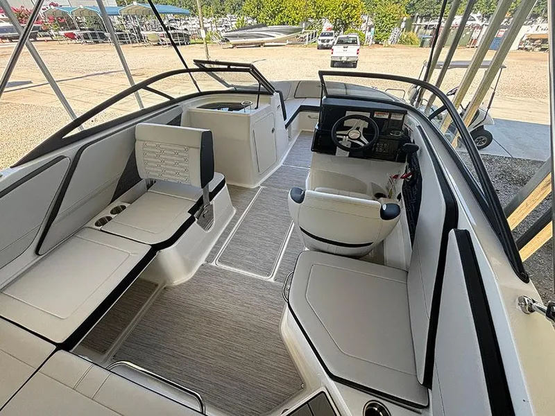 Slide: The Image of 2025 Sea Ray SPX 210 boat interior with modern seating and steering console. - 5