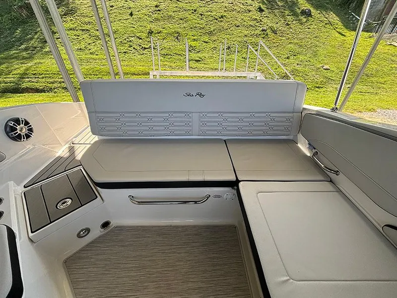 Slide: The Image of 2025 Sea Ray SPX 210 boat interior with cushioned seating and sleek design. - 7