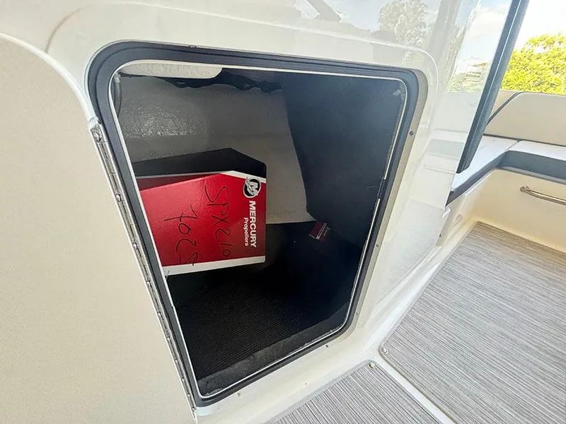 Slide: The Image of Storage compartment in 2025 Sea Ray SPX 210 boat with Mercury box inside. - 9