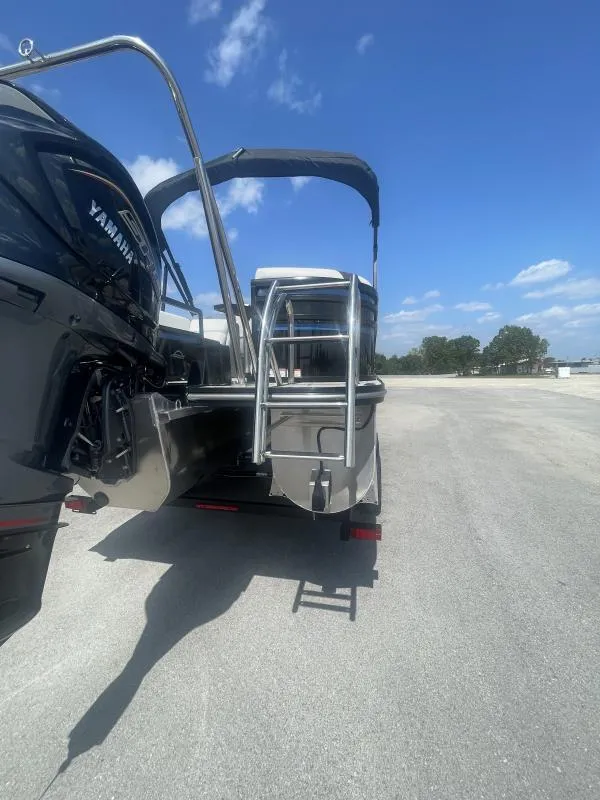 Slide: The Image of 2025 G3 SunCatcher V322 RC boat with Yamaha engine, rear view under clear sky. - 20