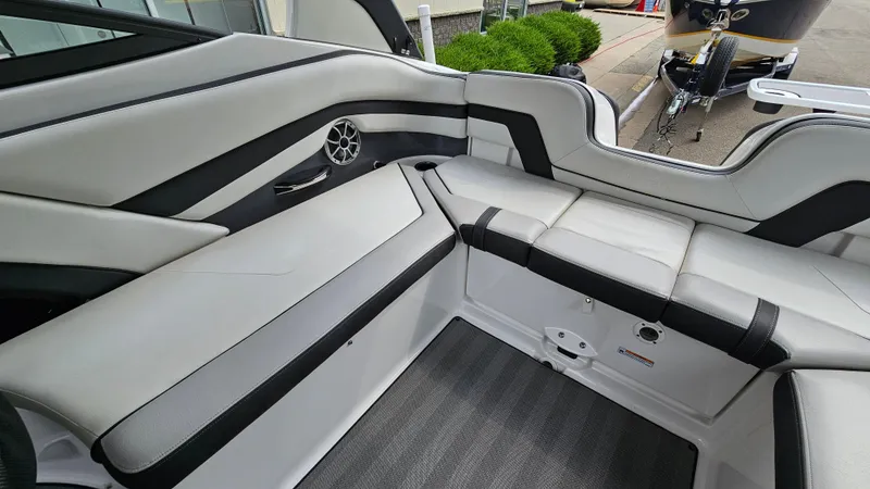 Slide: The Image of 2019 Yamaha Boats 242 LIMITED S E SERIES interior with sleek white and black seating. - 10