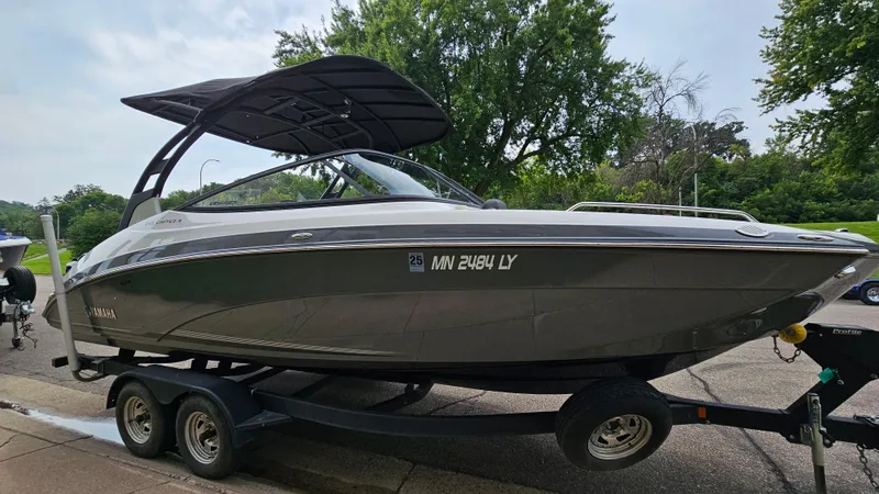 Slide: The Image of 2019 Yamaha Boats 242 LIMITED S E SERIES on trailer, parked outdoors. - 2