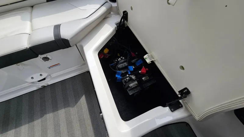 Slide: The Image of 2019 Yamaha Boats 242 LIMITED S E SERIES battery compartment with open hatch. - 28