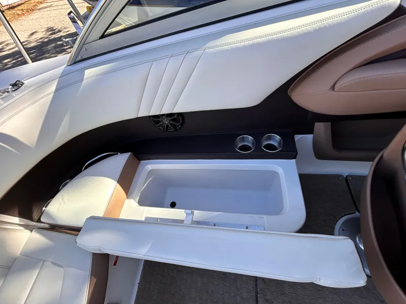 Slide: The Image of 2012 Cobalt 232 Bowrider interior with white seating and built-in cup holders. - 13