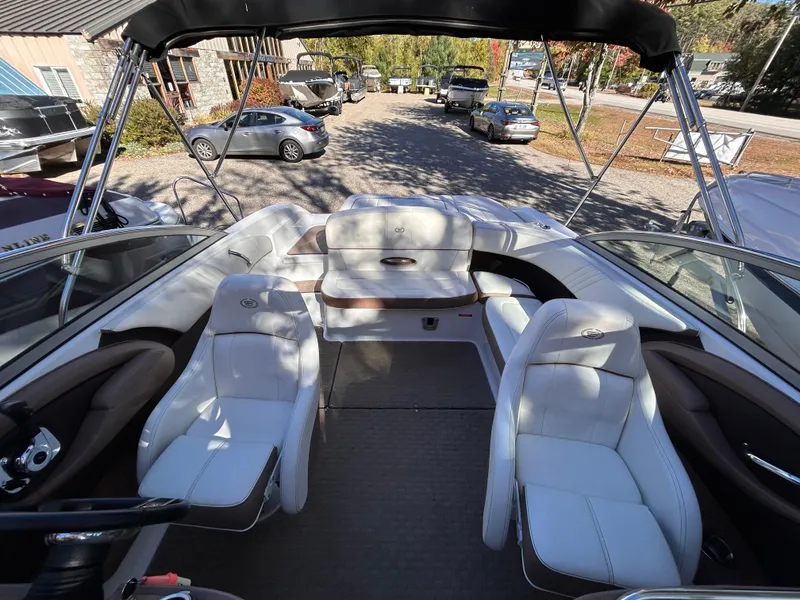 Slide: The Image of 2012 Cobalt 232 Bowrider interior with white seating and open deck layout. - 14