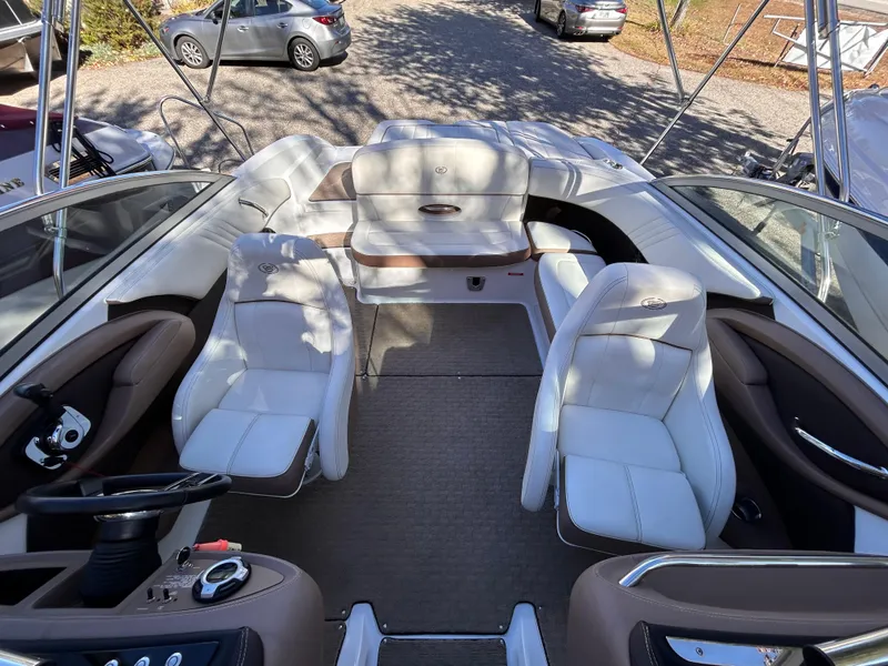 Slide: The Image of 2012 Cobalt 232 Bowrider interior with white seating and steering wheel. - 15