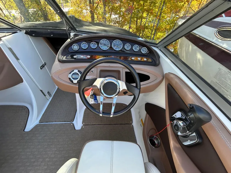 Slide: The Image of Interior view of 2012 Cobalt 232 Bowrider boat cockpit with steering wheel and controls. - 17