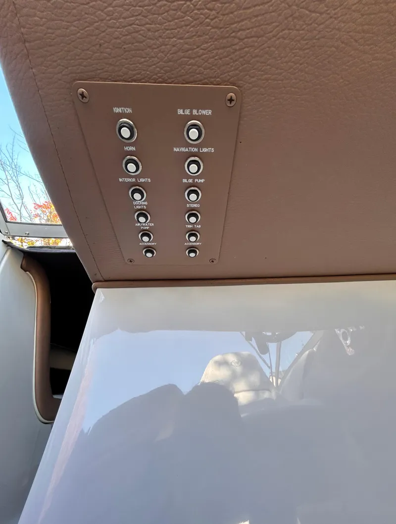 Slide: The Image of Control panel of 2012 Cobalt 232 Bowrider boat with various switches. - 19