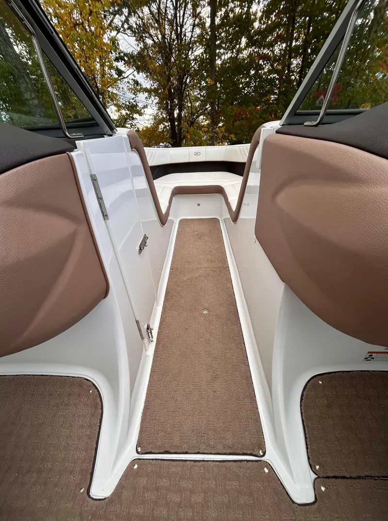 Slide: The Image of Interior view of 2012 Cobalt 232 Bowrider boat with brown seating and carpet. - 23