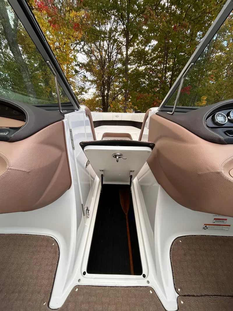 Slide: The Image of Interior view of 2012 Cobalt 232 Bowrider boat with open storage compartment. - 24