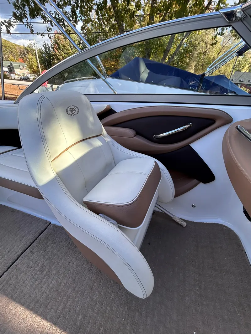 Slide: The Image of 2012 Cobalt 232 Bowrider interior with white and brown seating, sleek design. - 26