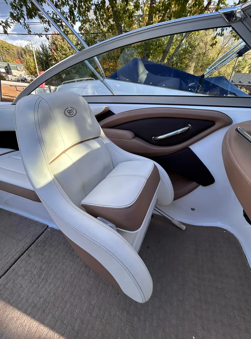 Slide: The Image of 2012 Cobalt 232 Bowrider interior with white and brown seating, sleek design. - 27