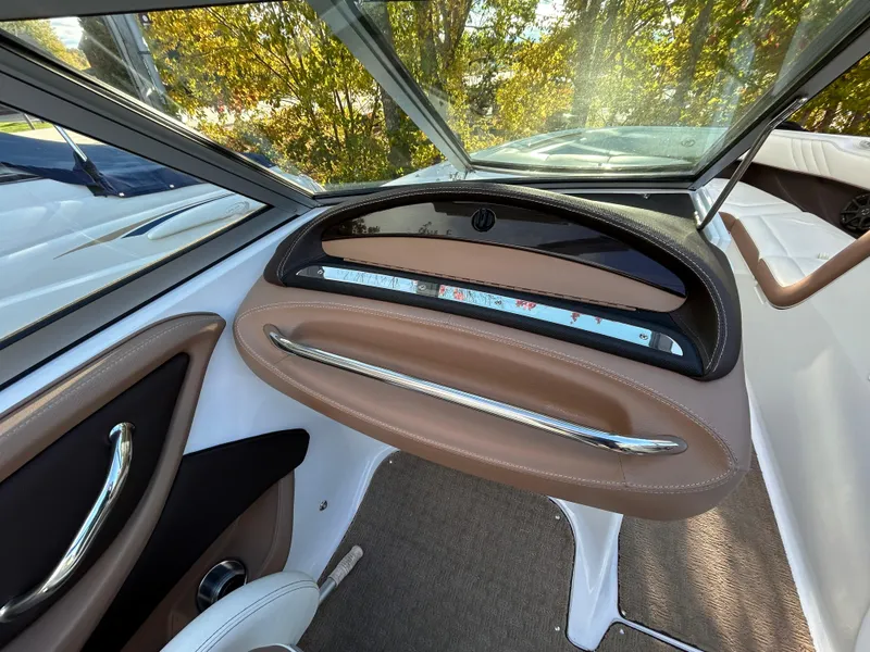 Slide: The Image of Interior of 2012 Cobalt 232 Bowrider boat with sleek dashboard design. - 29