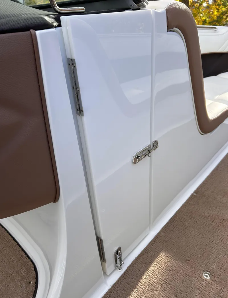 Slide: The Image of 2012 Cobalt 232 Bowrider interior door with brown and white design. - 31