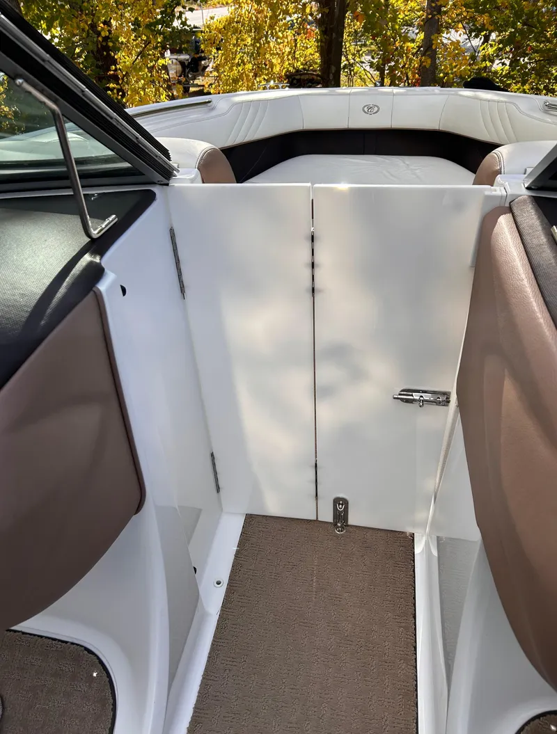 Slide: The Image of Interior view of 2012 Cobalt 232 Bowrider boat with open cabin door. - 33