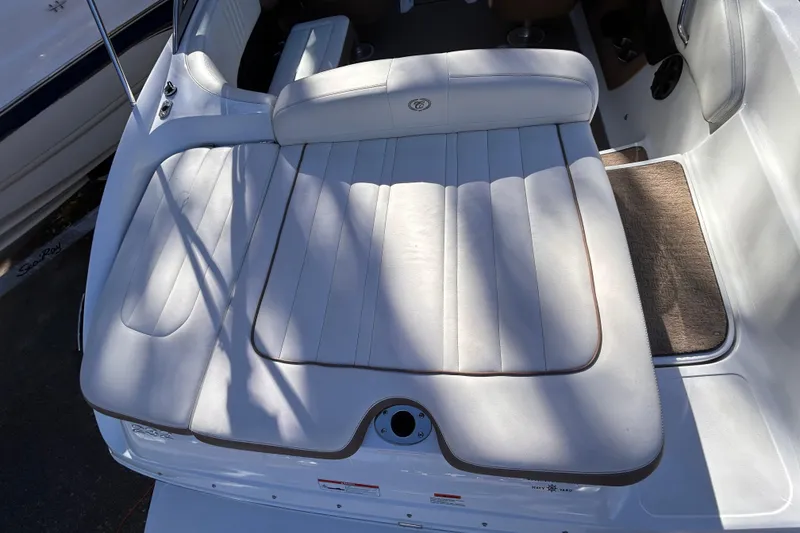 Slide: The Image of 2012 Cobalt 232 Bowrider boat with white cushioned seating area. - 7