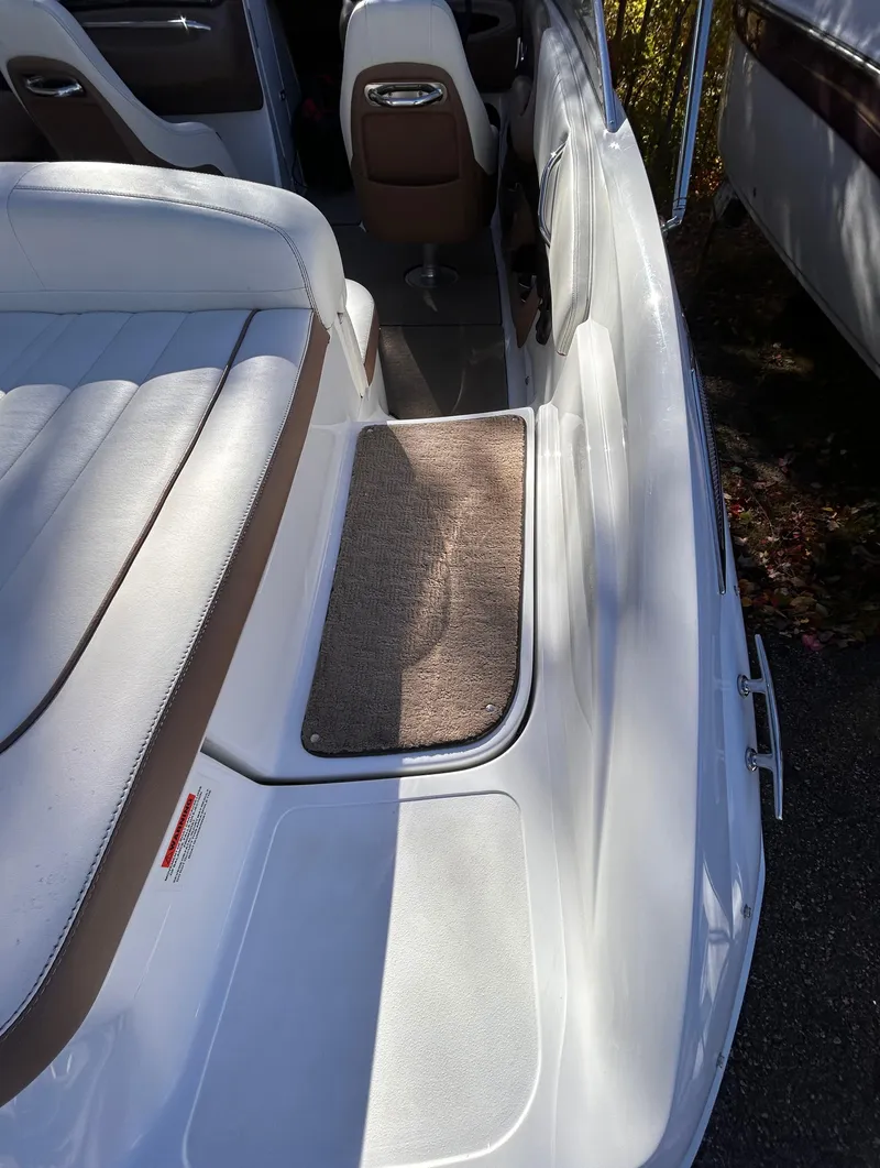 Slide: The Image of 2012 Cobalt 232 Bowrider interior with white seating and brown accents. - 8