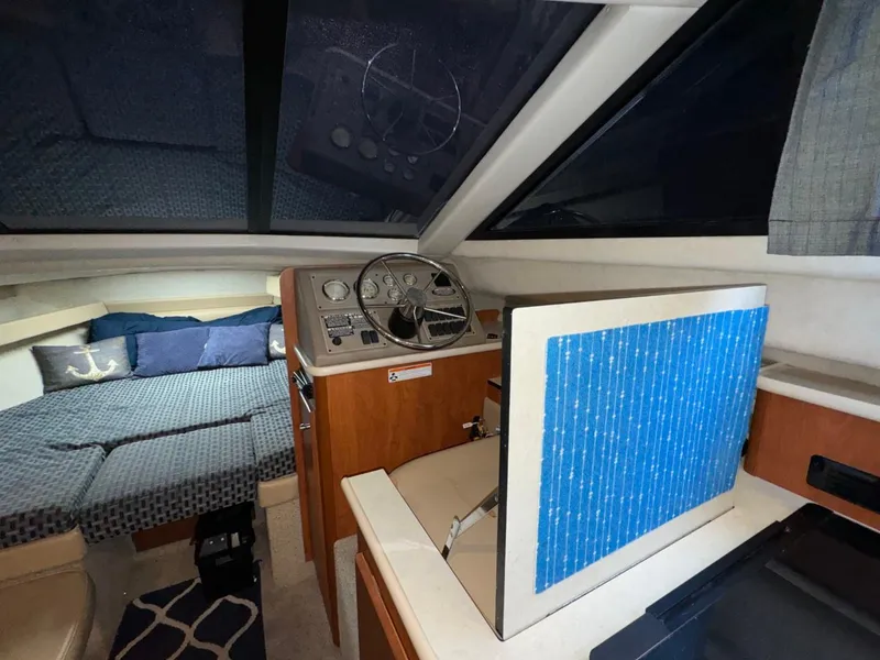 Slide: The Image of Interior of 2005 Bayliner 288 Classic boat with helm and cozy sleeping area. - 10