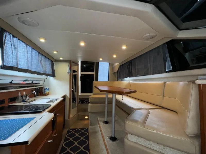 Slide: The Image of Interior of 2005 Bayliner 288 Classic boat with kitchen and seating area. - 11