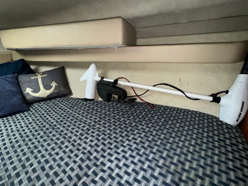 Slide: The Image of Interior of 2005 Bayliner 288 Classic with anchor-themed pillow and patterned bedding. - 15