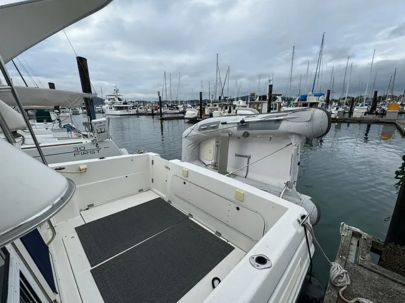 Slide: The Image of 2005 Bayliner 288 Classic docked at marina with inflatable boat. - 2