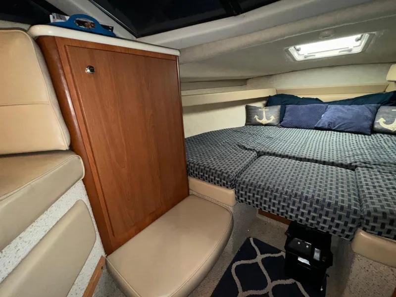Slide: The Image of Interior of 2005 Bayliner 288 Classic boat with cozy sleeping area and wooden cabinetry. - 4