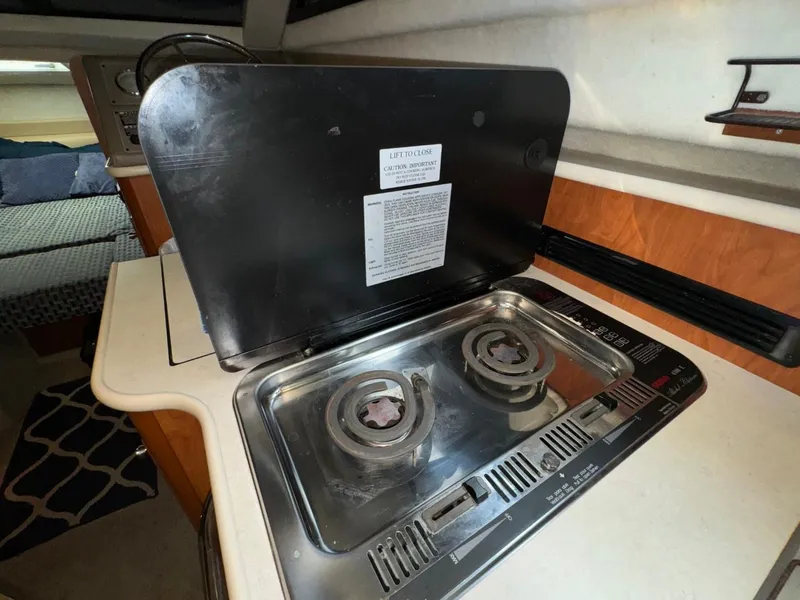 Slide: The Image of 2005 Bayliner 288 Classic boat interior with a compact two-burner stove. - 7