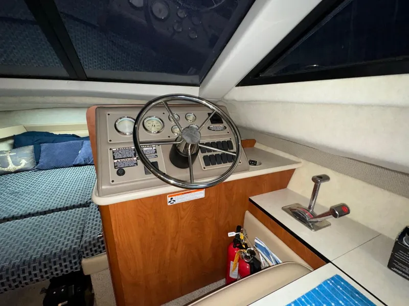Slide: The Image of 2005 Bayliner 288 Classic boat interior with steering wheel and control panel. - 9