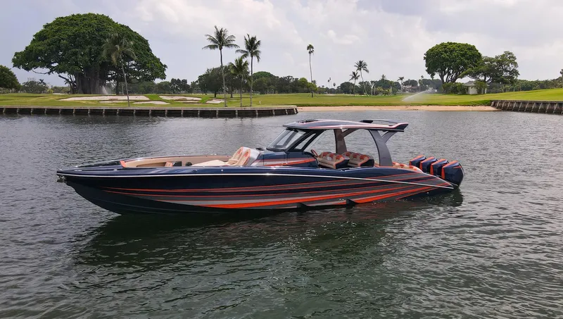 Slide: The Image of 2024 MTI V42 boat on water, sleek design, vibrant colors, tropical background. - 1