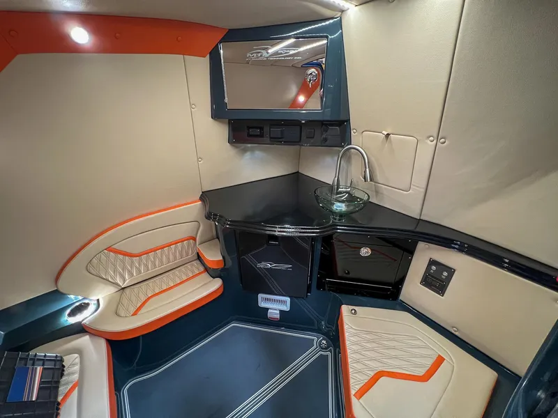 Slide: The Image of 2024 MTI V42 cabin interior with modern seating, sleek design, and compact kitchenette. - 10