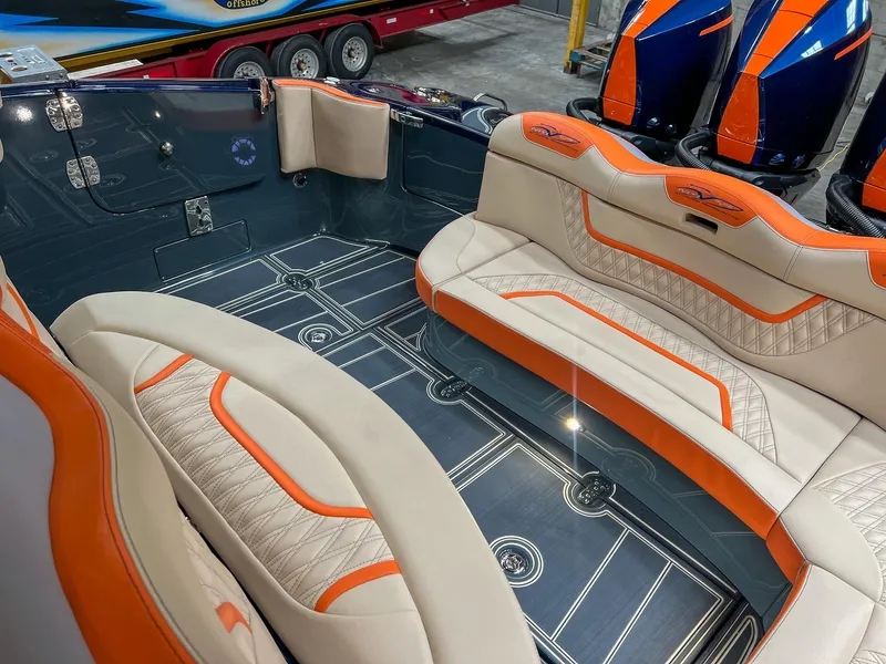 Slide: The Image of Luxurious MTI V42 2024 boat interior with orange and beige seating. - 13