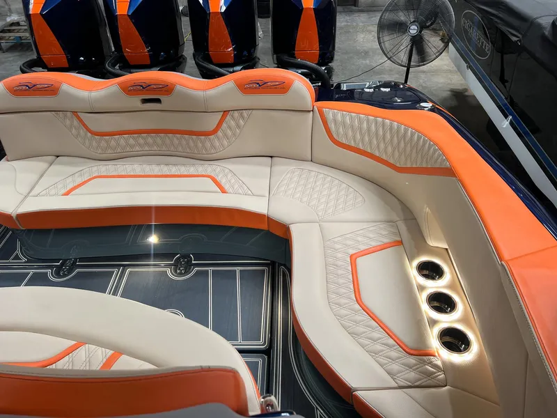 Slide: The Image of Luxurious MTI V42 2024 boat interior with orange and beige seating, cup holders, and sleek design. - 14